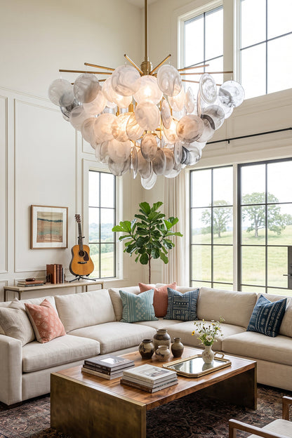 Nimbus Smoked Glass Disc Chandelier illuminates a stylish living room with modern decor and natural light.