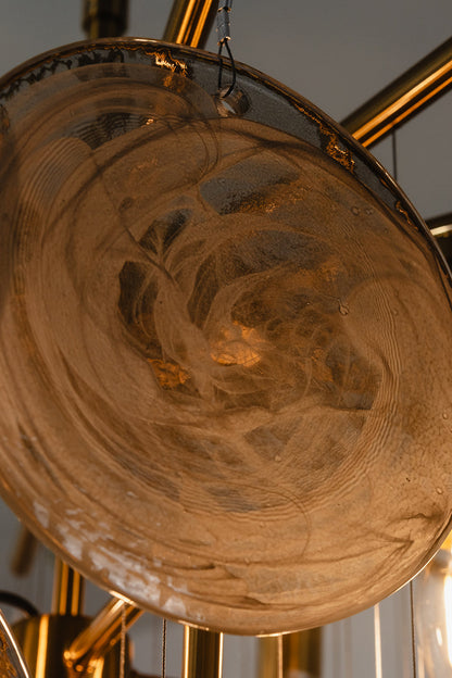Close-up of Nimbus Smoked Glass Disc Chandelier showcasing hand-blown glass disc with swirling patterns.