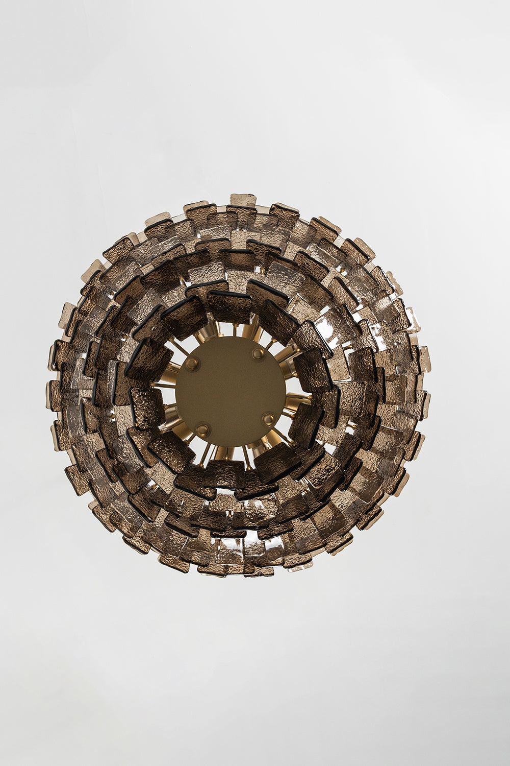Octavia Sculptural Smoked Glass Chandelier | Ceiling Perspective | Alternative bottom-up studio view of the circular sculptural glass chandelier against a clean white backdrop | vexa lamps