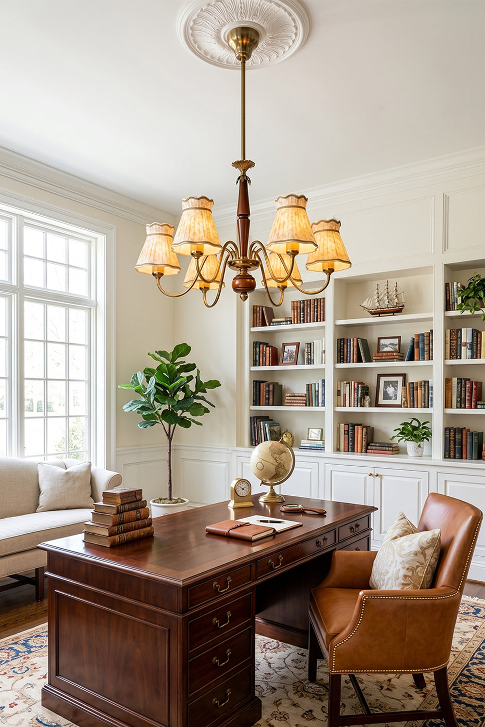 Odette Vintage Pleated Shaded Chandelier | Wood, Brass, Fabric | Placed as a statement light fixture in a classic home office or library space above a large dark wood executive desk and leather chair | vexa lamps