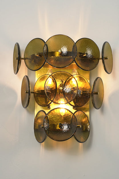 Lit tiered olive green hammered glass wall light | Metal, Glass | Angled lit product view showing tiered layers | vexa lamps
