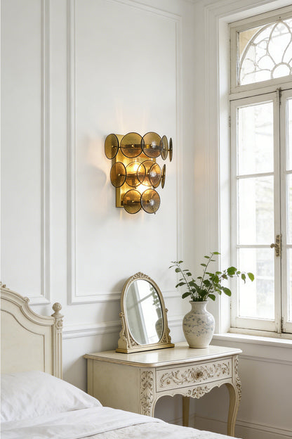 Lit olive green glass wall sconce | Metal, Glass | Installed in a classic bedroom near a white dresser and mirror | vexa lamps