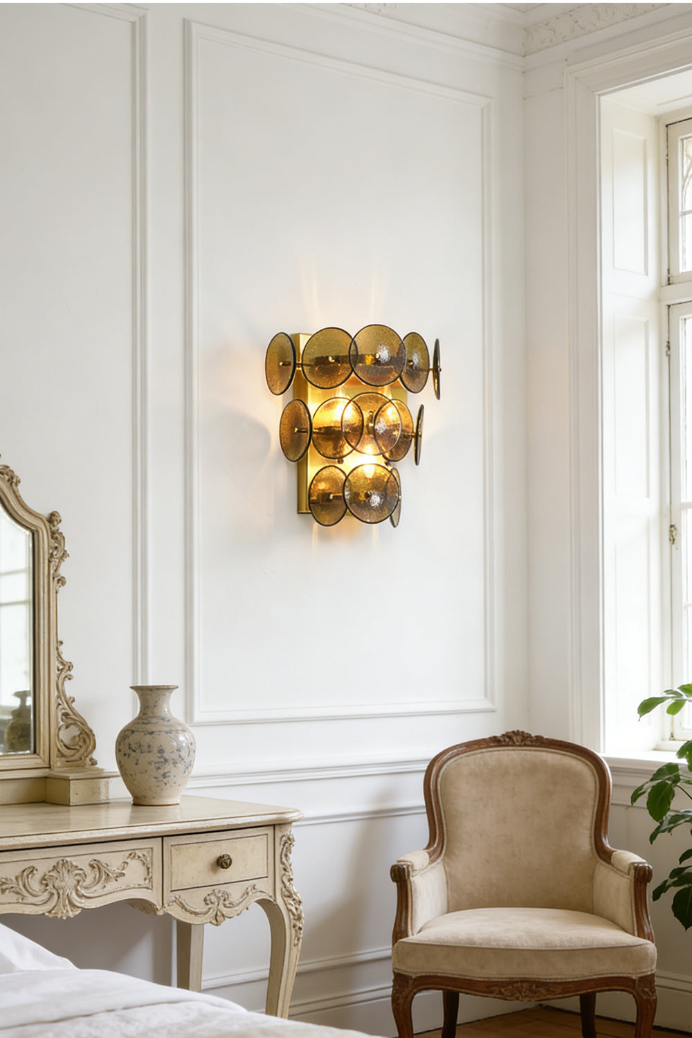 Lit tiered olive green wall light | Metal, Glass | Installed in a traditional living area near white wainscoting | vexa lamps