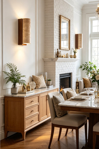 Outcrop Beige Travertine Wall Sconce | Travertine, Metal | Illuminating a sophisticated dining room, mounted on the wall near a wooden sideboard cabinet and a formal dining table | vexa lamps