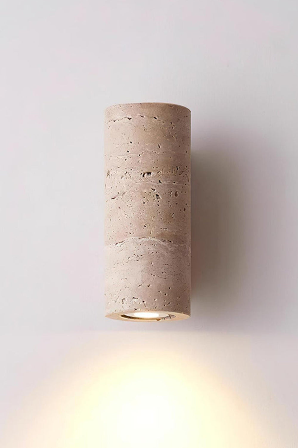 Outcrop Beige Travertine Wall Sconce | Travertine, Metal | Studio front view of the fully illuminated travertine wall fixture casting a powerful warm downlight against a white background | vexa lamps