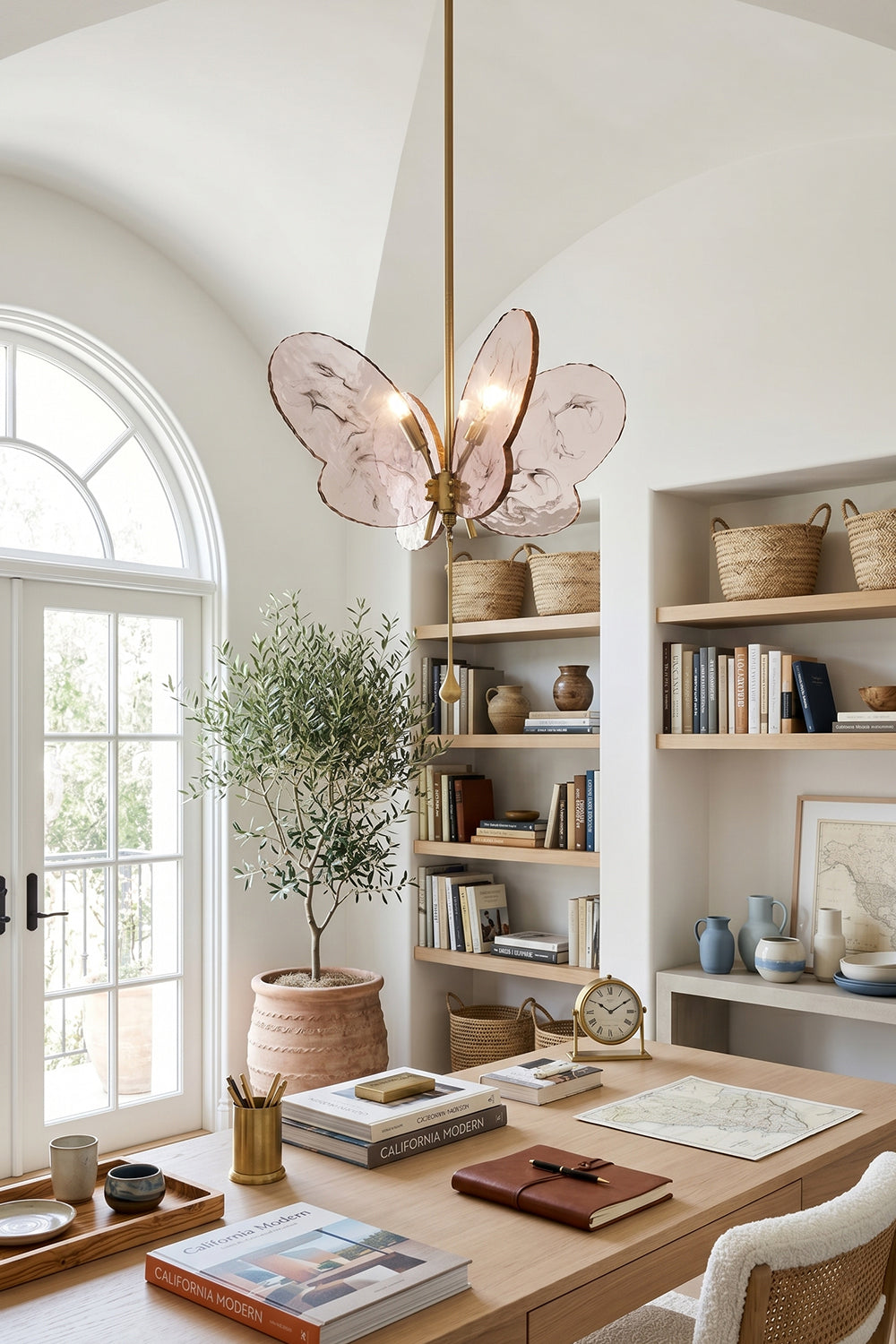 Papillon Glass Butterfly Pendant Lamp | Glass, Metal | Pink variant casting a warm glow in a bright, modern home office workspace above a wooden executive desk | vexa lamps
