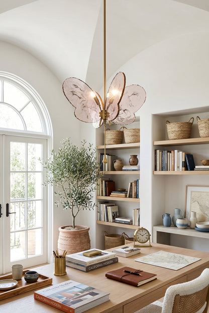 Papillon Glass Butterfly Pendant Lamp | Glass, Metal | Pink variant casting a warm glow in a bright, modern home office workspace above a wooden executive desk | vexa lamps