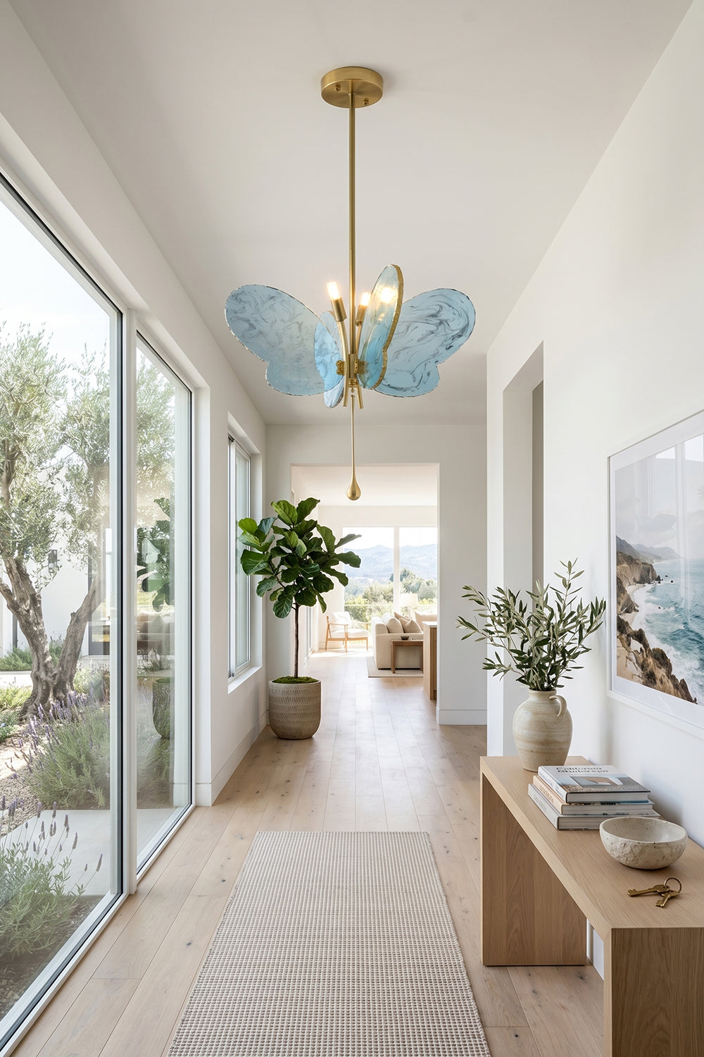 Papillon Glass Butterfly Pendant Lamp | Glass, Metal | Blue glass butterfly pendant installed along a long, bright minimalist hallway with sliding glass doors | vexa lamps