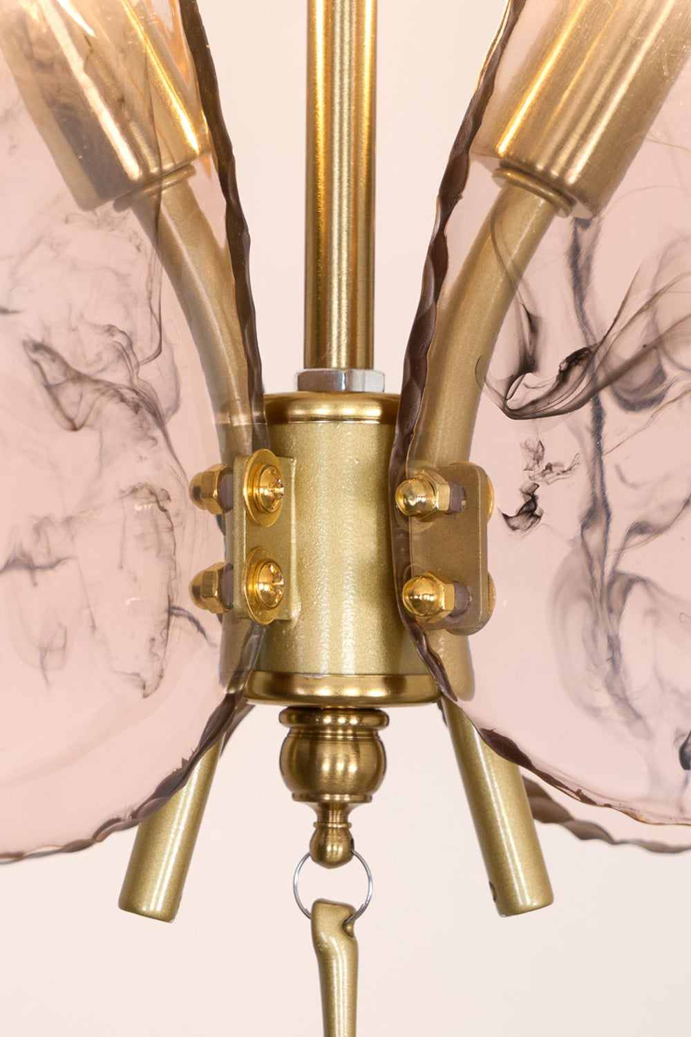 Papillon Glass Butterfly Pendant Lamp | Glass, Metal | Macro close-up focus on the gold brass central body connector and the textured veined pink glass wings | Detail shot | vexa lamps