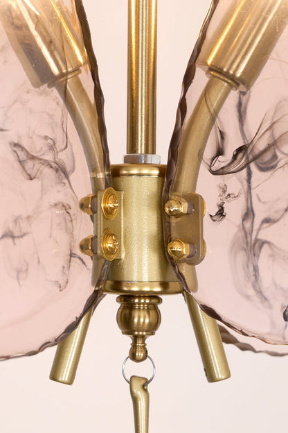 Papillon Glass Butterfly Pendant Lamp | Glass, Metal | Macro close-up focus on the gold brass central body connector and the textured veined pink glass wings | Detail shot | vexa lamps