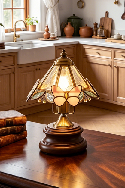 Papillon Heirloom Stained Table Lamp | Wood, Glass, Metal | Closer view of the glowing heirloom lamp on a rich wood surface in a farmhouse-style kitchen | vexa lamps