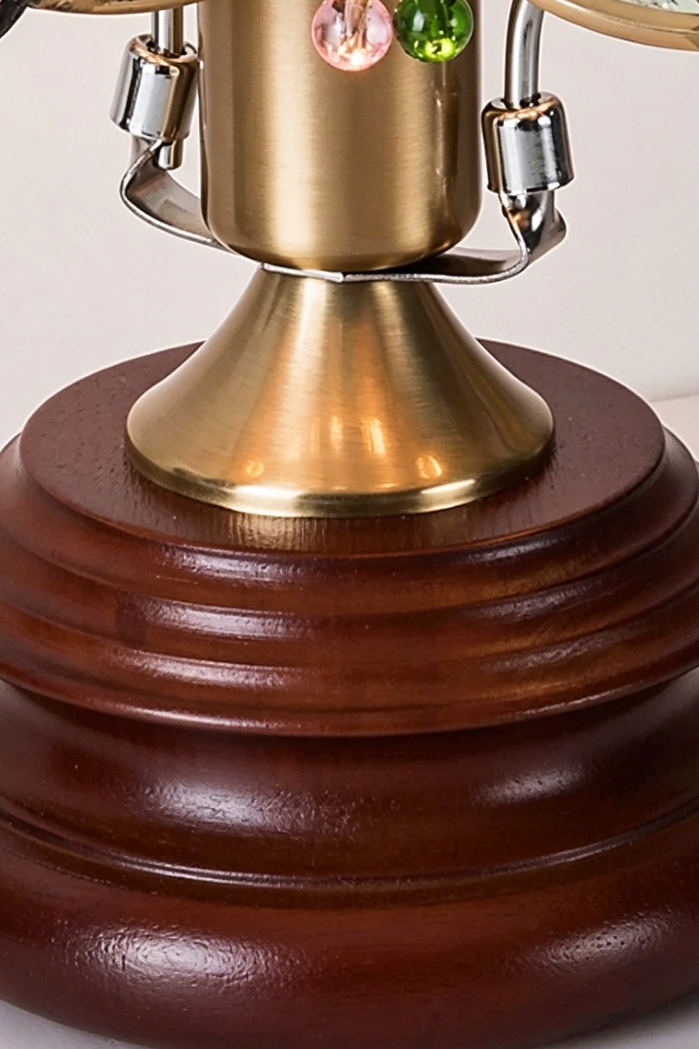 Papillon Heirloom Stained Table Lamp | Wood, Glass, Metal | Close-up focus on the brushed brass neck connector and the tiered, turned dark wood pedestal base | Detail shot | vexa lamps
