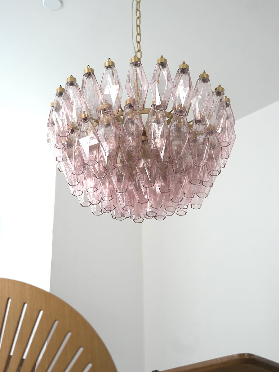 Pink art glass tiered chandelier in a modern hallway | Metal, Glass | High-ceiling installation over a corner seat | vexa lamps
