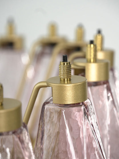 Detailed shot of brass hooks and pink glass attachment | Metal, Glass | Focusing on the faceted glass surface | vexa lamps
