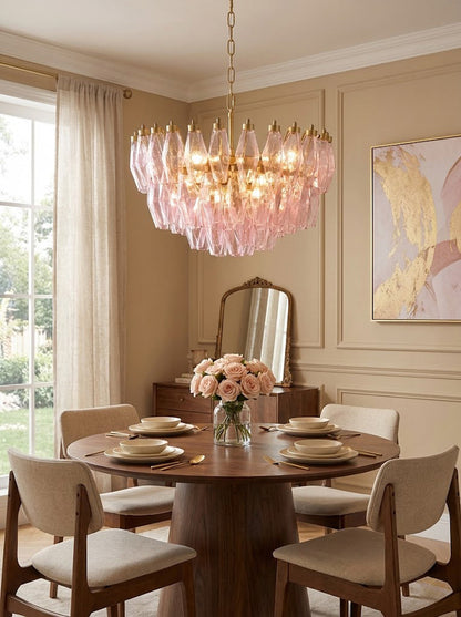 Pink polyhedron glass chandelier over round dining table | Metal, Glass | Interior scene with beige chairs and pink wall art | vexa lamps