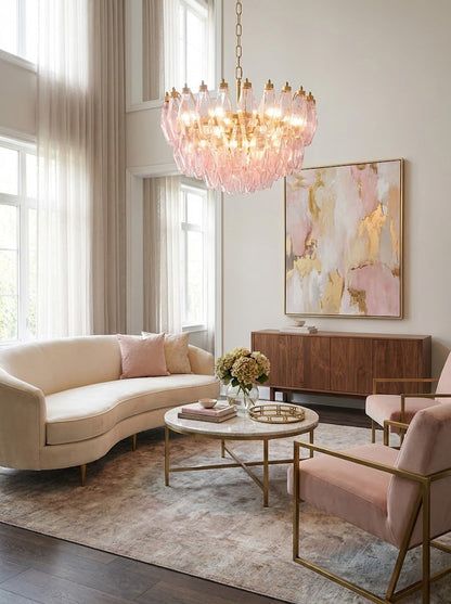 Tiered pink polyhedron glass light fixture | Metal, Glass | Living room scene with curved sofa and pink abstract art | vexa lamps
