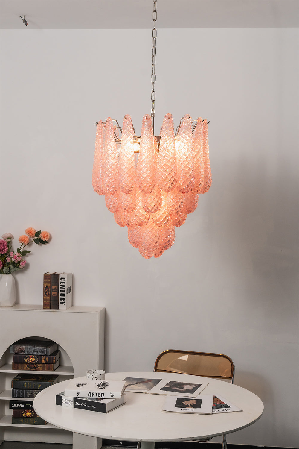 Amara Blush Cascading Glass Chandelier | Glass, Metal | Hanging over a small round white table and chair in a minimalist residential corner | vexa lamps