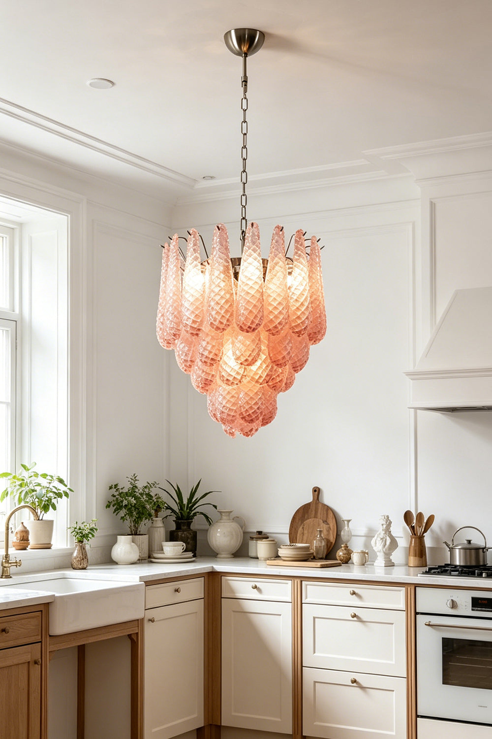 Amara Blush Cascading Glass Chandelier | Glass, Metal | Providing warm ambient light in a bright classic kitchen with cream cabinetry and wood floors | vexa lamps
