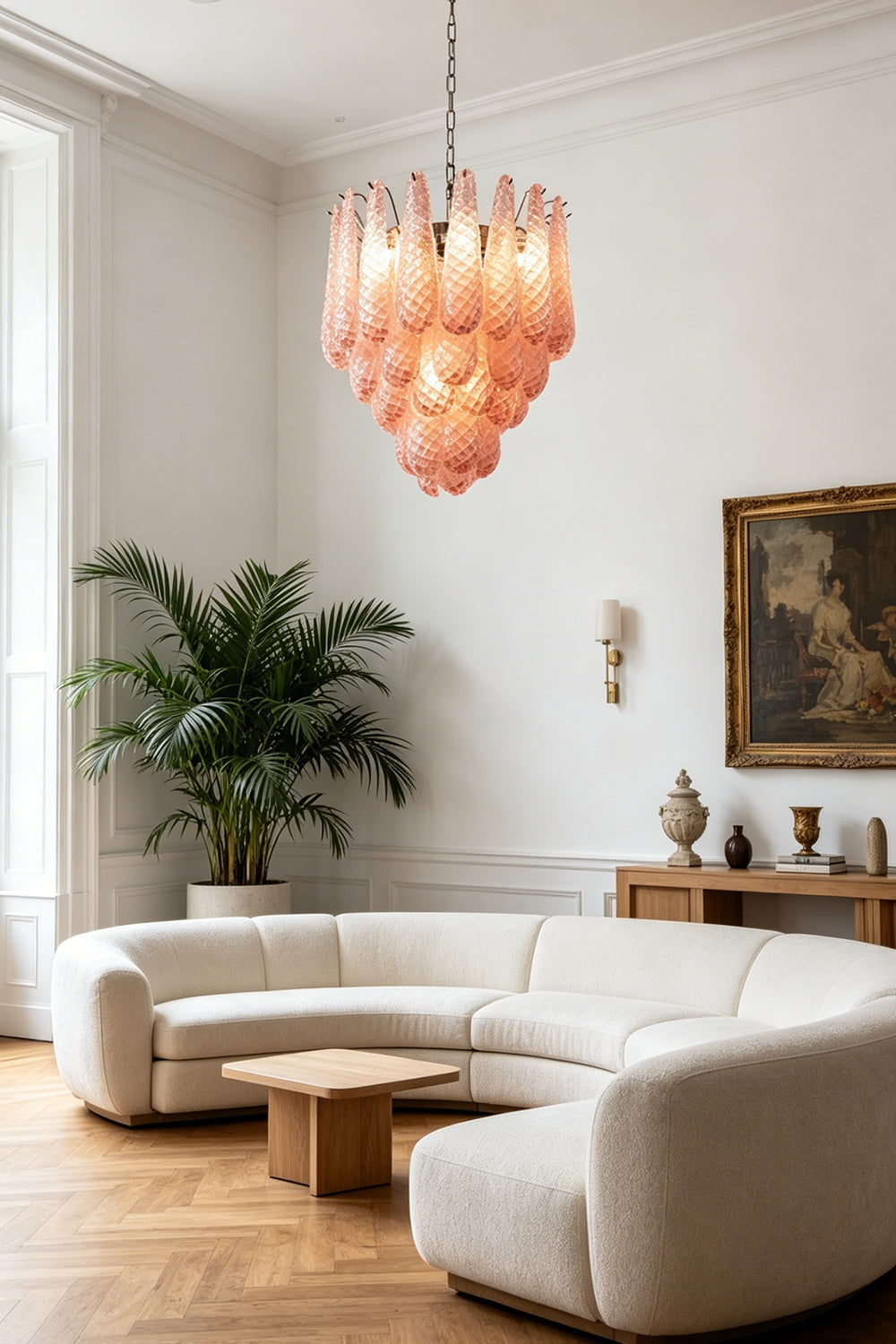 Amara Blush Cascading Glass Chandelier | Glass, Metal | Illuminating a contemporary living room with a curved cream sofa and a wooden coffee table | vexa lamps