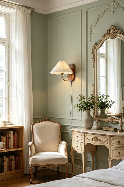 Pleated Fabric Wall Lamp | Fabric, Metal, Wood | Mounted beside a classic vanity table and mirror in a serene room with light green walls and an accent armchair | vexa lamps