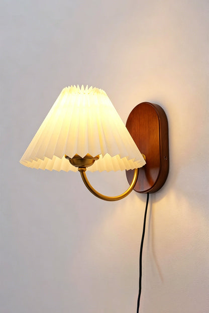 Pleated Fabric Wall Lamp | Fabric, Metal, Wood | Frontal angled view of the fully lit vintage pleated sconce throwing a warm golden backlight halo onto a neutral wall | Isolated shot | vexa lamps