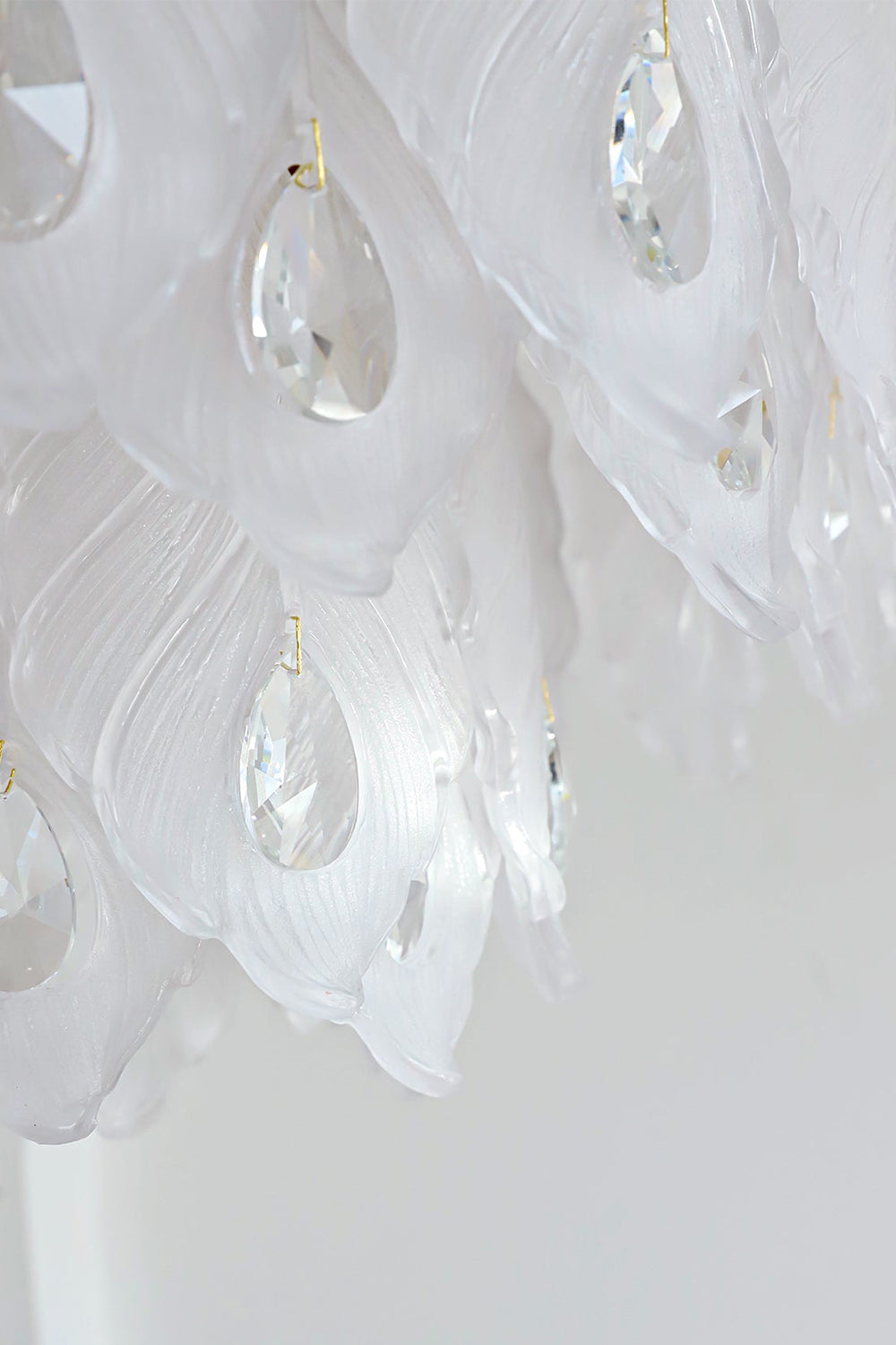 Pluma Frosted Glass Feather Chandelier | Glass, Metal | Detailed close-up profile showing the overlapping layered frosted glass feather panels and smooth clear crystal pendants under bright studio light | Detail shot | vexa lamps