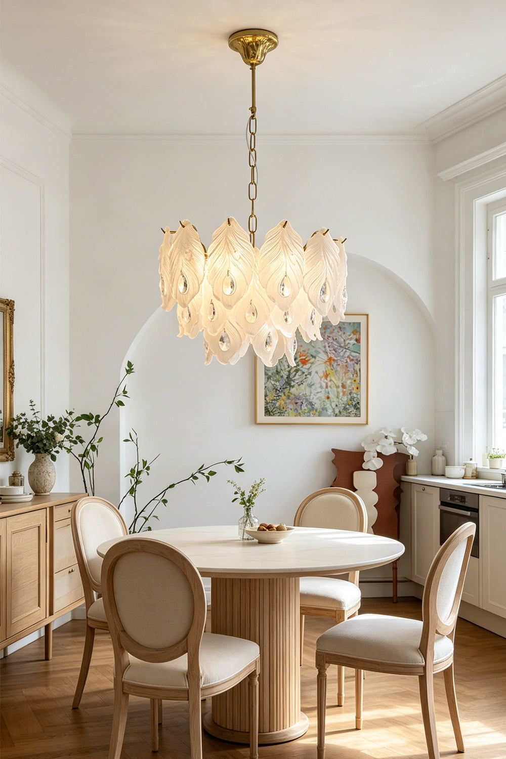 Pluma Frosted Glass Feather Chandelier | Glass, Metal | Hanging as a luxurious centerpiece over a round wooden dining table with round-back chairs in a bright classical room | vexa lamps