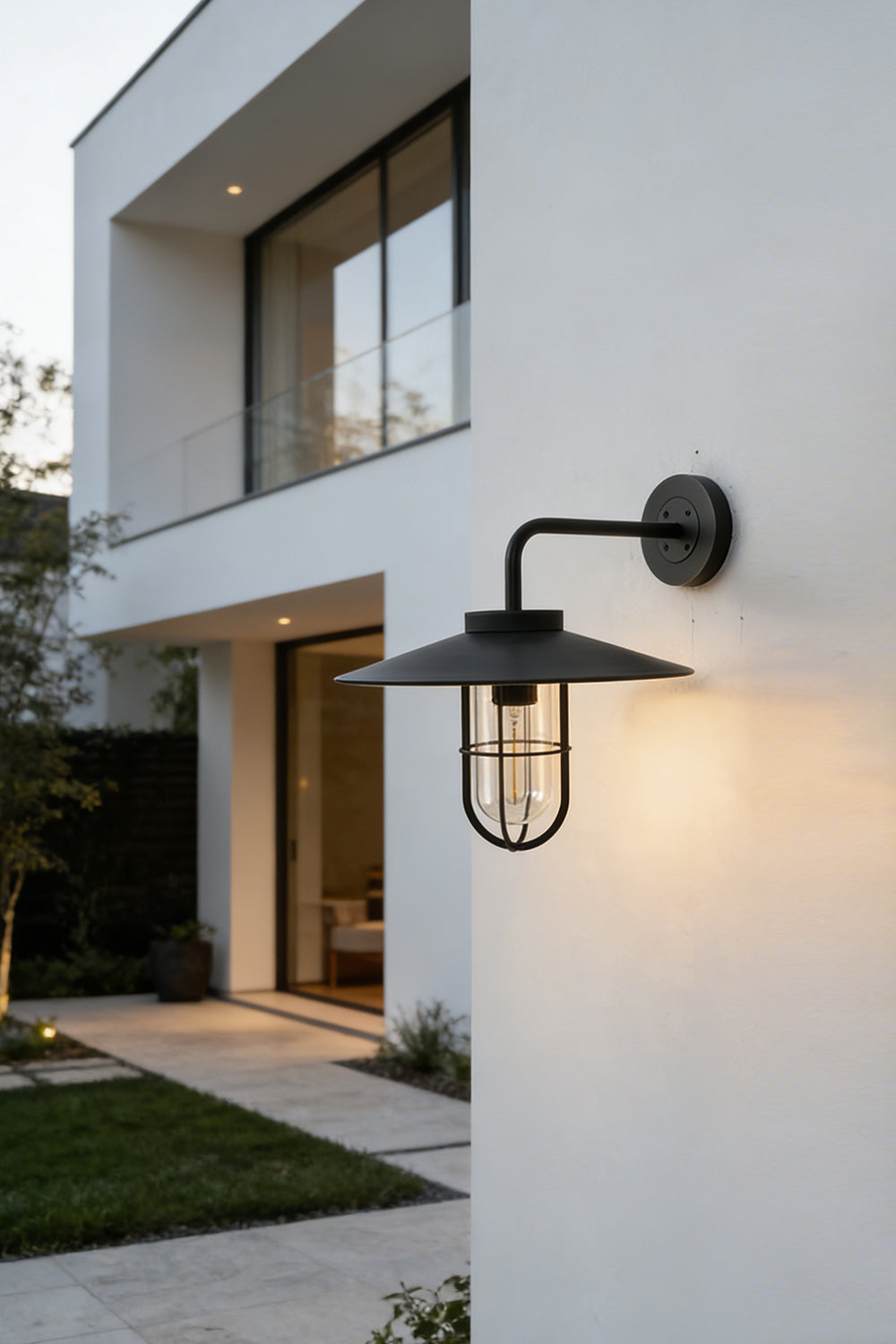 Portree wall light in black finish on modern exterior wall | Metal, Glass | Outdoor lighting scene at a contemporary house | vexa lamps
