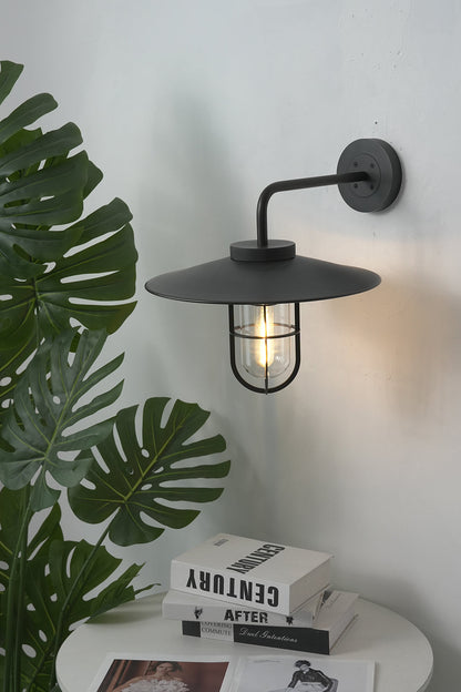 Black Portree wall lamp in a modern interior | Metal, Glass | Mounted near indoor plants and books | vexa lamps