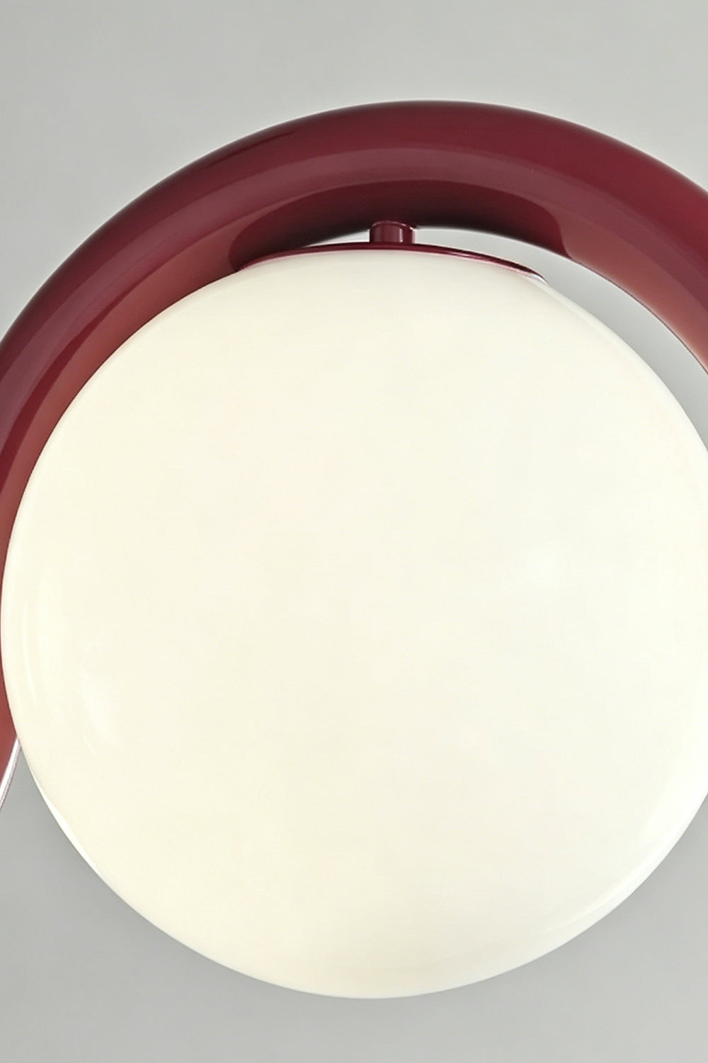Close-up of the burgundy rhythmic flow pendant lamp | Metal, Glass | Focusing on the curved metal frame and opal glass | vexa lamps