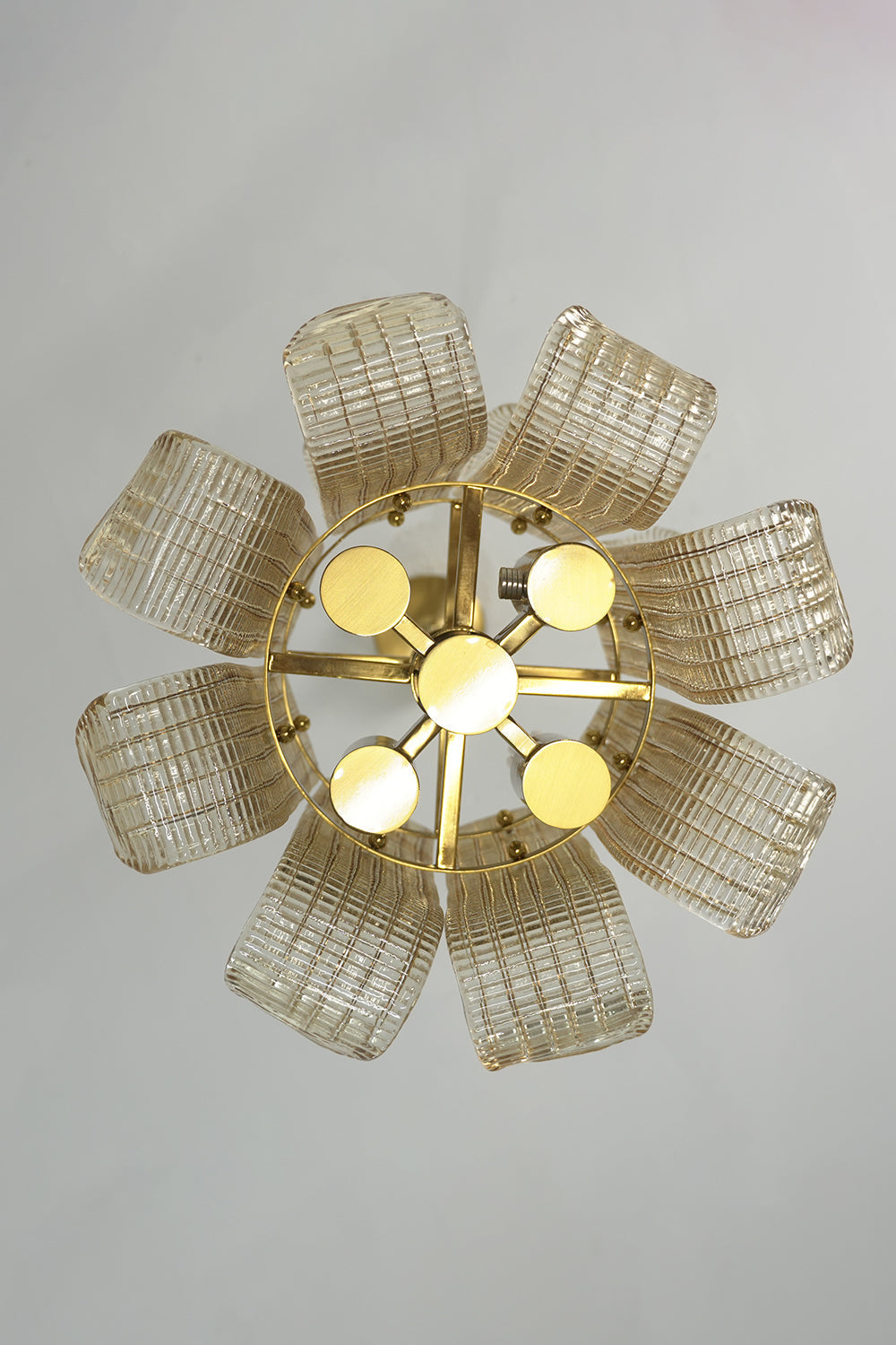 Ribbed glass scroll chandelier from below | Metal | Glass | Showing the flower-like symmetrical arrangement of glass panels | vexa lamps