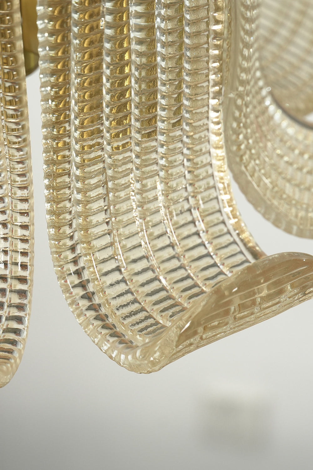 Ribbed glass texture and curved scroll edge | Glass | Macro shot of the high-quality glass paneling craftsmanship | vexa lamps