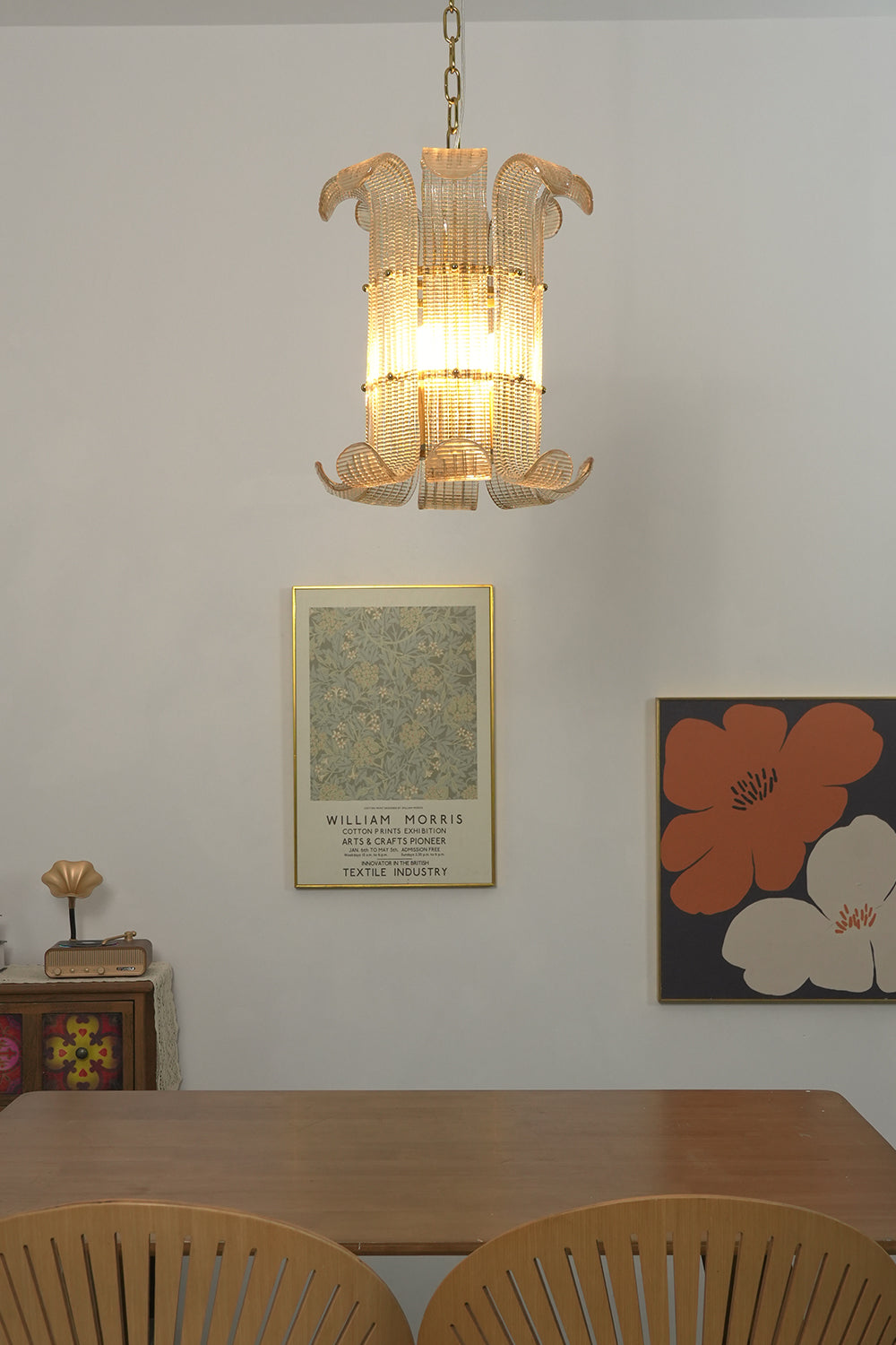 Ribbed glass scroll pendant lamp | Metal | Glass | Centered over a dining table with artistic wall decor | vexa lamps