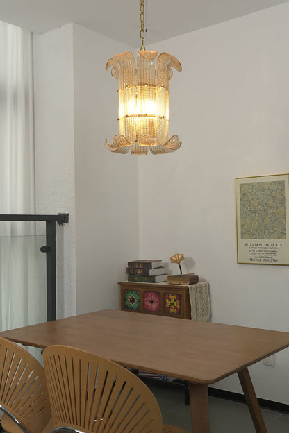Lit ribbed glass scroll chandelier | Metal | Glass | Low-angle view looking up at the warm glowing frame | vexa lamps