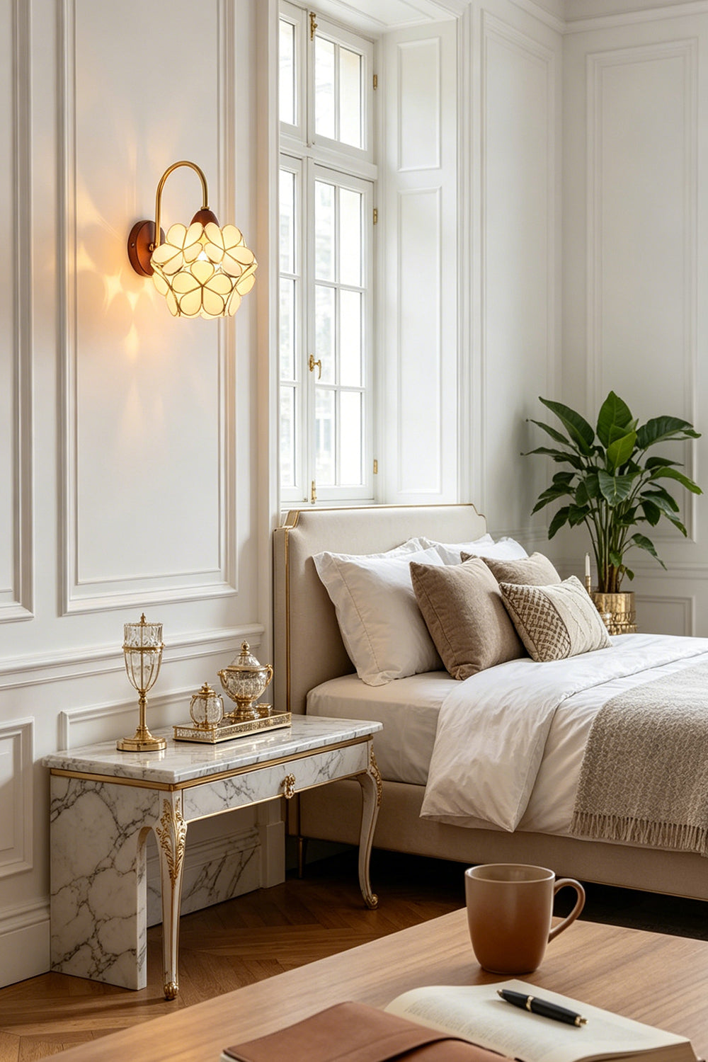 Rosalind Petal Glass Botanical Wall Lamp | Glass, Metal, Wood | Installed as a charming bedside reading light on a white paneled wall next to a bed with neutral linens | vexa lamps