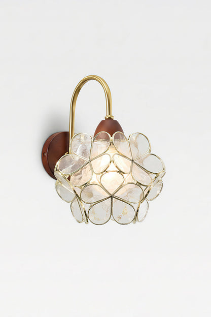 Rosalind Petal Glass Botanical Wall Lamp | Glass, Metal, Wood | Isolated lit product view of the white glass petal variant casting soft illumination against a white studio background | vexa lamps