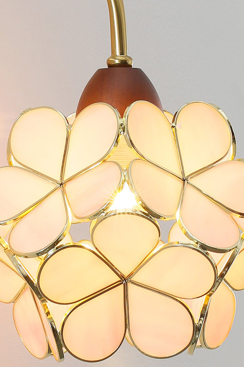 Rosalind Petal Glass Botanical Wall Lamp | Glass, Metal, Wood | Close-up focus on the fully illuminated warm yellow glass flower variant radiating a cozy vintage glow | Detail shot | vexa lamps