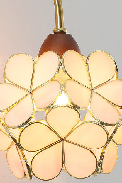 Rosalind Petal Glass Botanical Wall Lamp | Glass, Metal, Wood | Close-up focus on the fully illuminated warm yellow glass flower variant radiating a cozy vintage glow | Detail shot | vexa lamps
