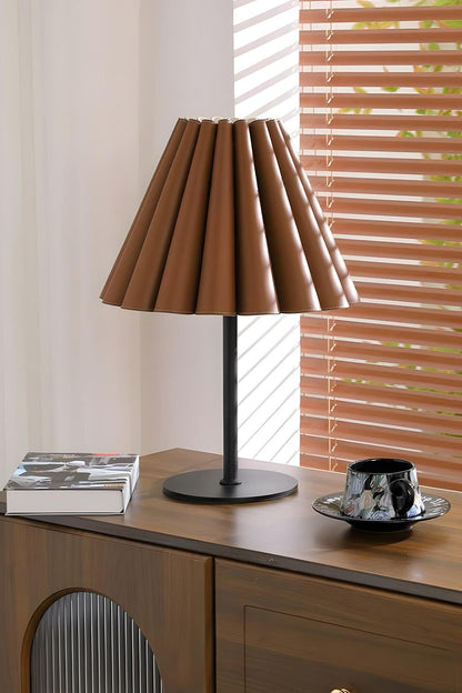 Rowan Leather Pleated Table Lamp | Leather, Metal | Situated on a sleek dark wood sideboard cabinet near window blinds in a contemporary workspace | vexa lamps