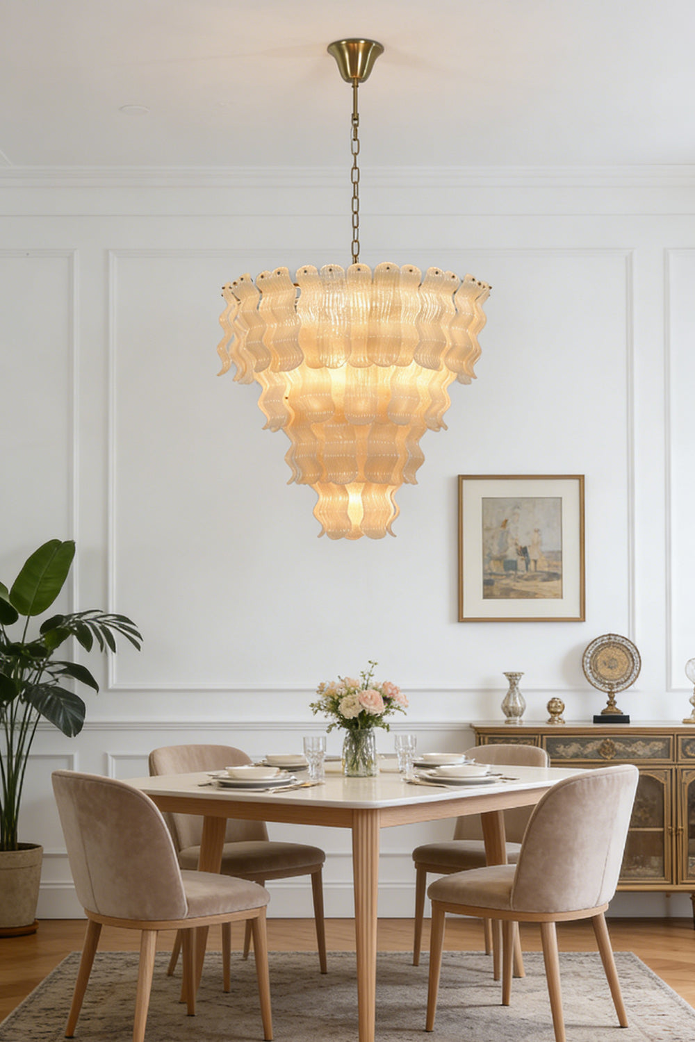 Ruffled glass chandelier for dining area | Metal | Glass | Installed over a small dining table with wooden chairs | vexa lamps