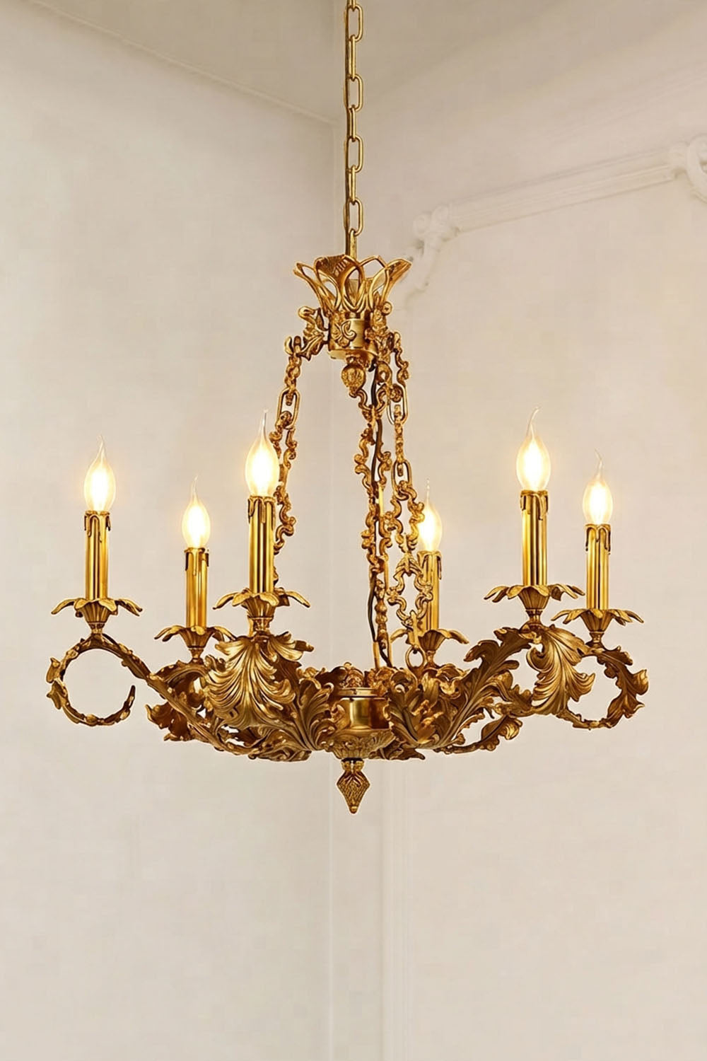 Rurik Acanthus Leaf Brass Chandelier with six candle holders and ornate leaf design illuminating a modern interior.
