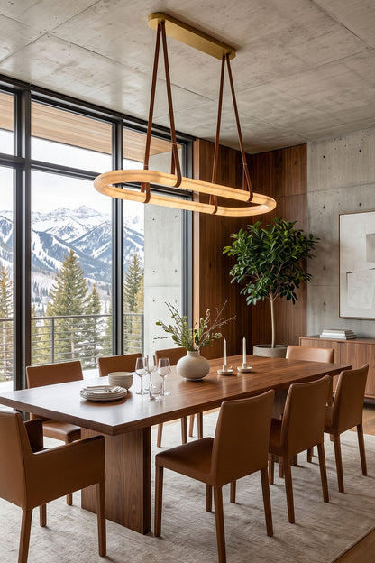 Selwyn Racetrack Alabaster Leather Pendant Light | Natural Alabaster, Leather and Metal | Suspended over a long wooden dining table with brown leather chairs | vexa lamps