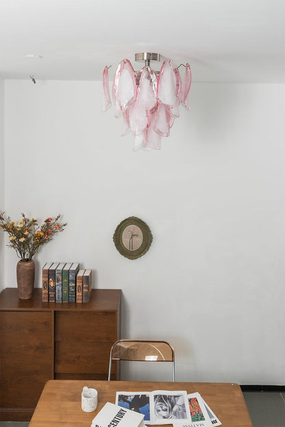 Pink petal glass ceiling light against a neutral wall | Metal, Glass | Side view showing the cascading petal layers | vexa lamps