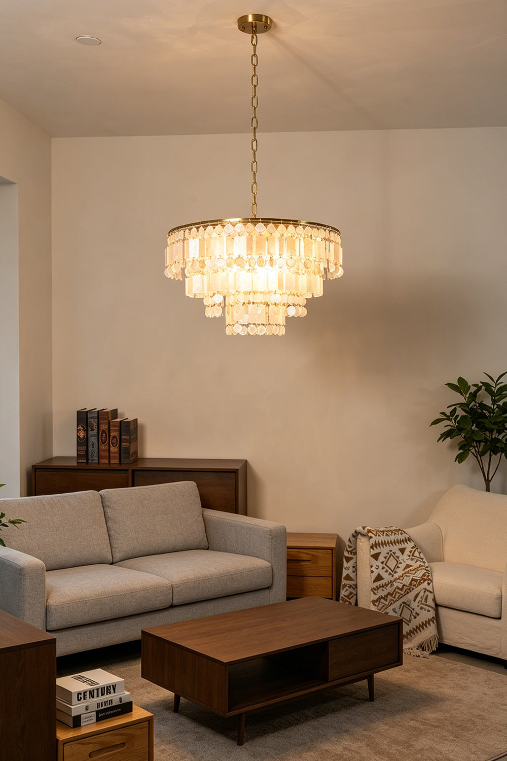 Seraphina Capiz Cascade Metal Chandelier illuminating a stylish living room with modern furniture.