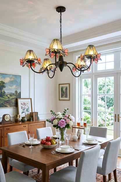 Seraphina Stained Glass Chandelier | Glass, Metal | Suspended over a wooden dining table and grey upholstered chairs in a bright modern dining area with a large window | vexa lamps