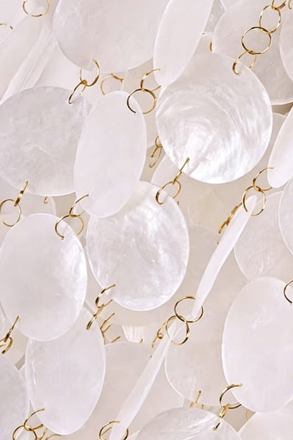 Close-up of cascading shell pieces | Shell | Iron | Detail of metal rings connecting white shell discs | vexa lamps
