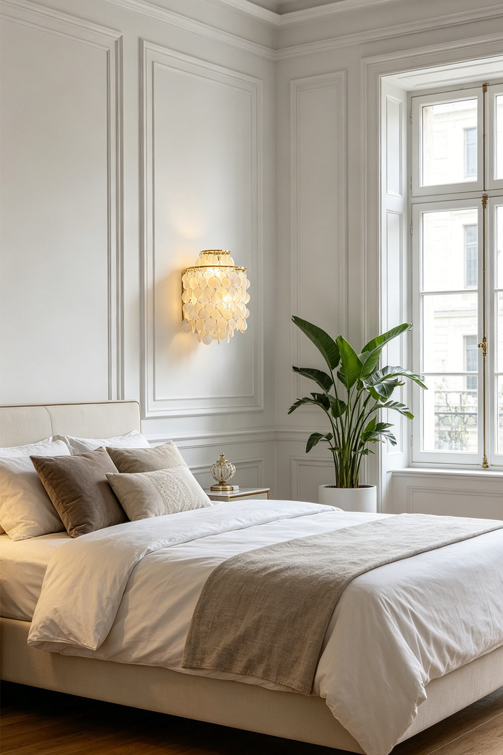 Serene shell cascading wall light | Shell | Iron | Mounted in a cozy bedroom above a white bed | vexa lamps