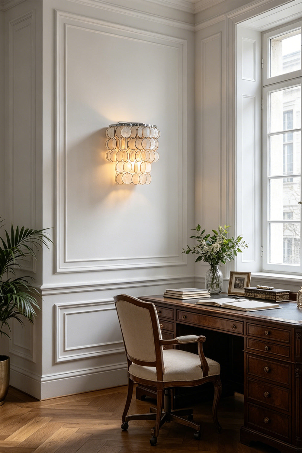 Shimmering Capiz wall lamp for home office | Shell | Iron | Installed above a vintage wooden desk by a window | vexa lamps
