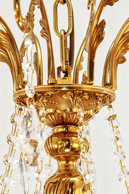 Sidonie Scrolled Brass Crystal Chandelier with intricate detailing and crystal embellishments.