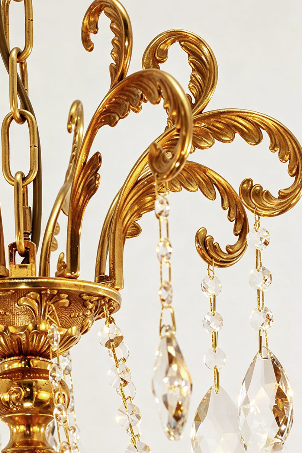 Close-up view of the Sidonie Scrolled Brass Crystal Chandelier showcasing intricate detailing and elegant crystal accents.
